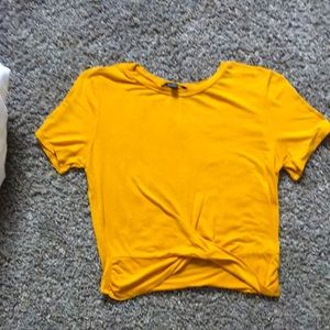 Soft and stretchy mustard colored tee shirt.
